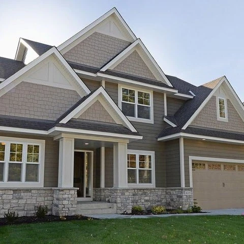 A finished two storey house with several intersecting gable roofs and a shingled roof covering